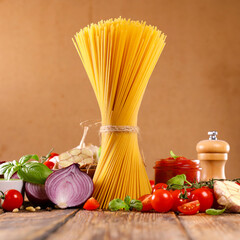 Wall Mural - raw italian food- spaghetti with raw ingredients for sauce