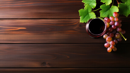 Wall Mural - Glasses of red wine and red grapes on a dark wooden table. View from above