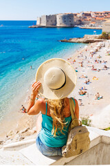 Wall Mural - Woman tourist enjoying view of Dubrovnik city and beach- Travel, tour tourism in Croatia