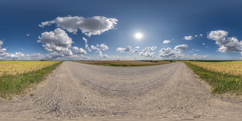 Wall Mural - 360 hdri panorama on gravel road with marks from car or tractor tires with clouds on blue sky in equ