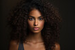Front view female portrait, young pretty African American woman model with curly hairstyle looking at camera