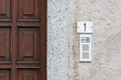 Simple intercom system next to a wooden door