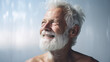 grandfather portrait in bright light, cheerful old man with a charming smile and white beard, looks to the left, with a pensive and dreamy look on a minimalist blue sky background