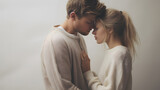 Fototapeta  - blonde couple kissing, white clothes, white background