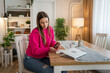 © Miljan Živković - one young woman read medical prescription hold medicine drugs at home