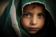 Portrait of a little young palestinian girl in a green scarf