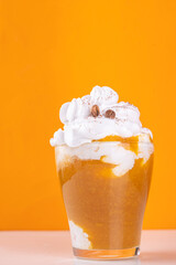 Wall Mural - Pumpkin spice latte in a glass cup