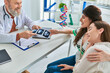 © LIGHTFIELD STUDIOS - smiling lesbian couple holding ultrasound of their baby from doctor, in vitro fertilization concept