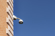 A Surveillance Camera Placed In A Corner Of A Building On A Day With The Sky Completely Free Of Clouds