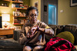 © Marko Geber - Senior African American woman checking her smartwatch at home before going out to exercise