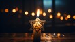 golden star of david on a black background. a candle is burning below