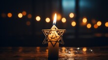 Golden Star Of David On A Black Background. A Candle Is Burning Below