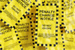Pile of yellow penalty charge notices. Illustration of the concept of parking tickets for illegal parking