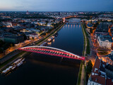 Fototapeta Miasto - Krakow, Poland, aerial view of the Kazimierz and Podgorze districts with Vistula river bridges in the night