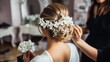 Young bride getting her hair done before wedding by professional hair stylist with elegant white flowers decorated on her hair, with copy space.