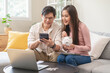 © Pormezz - financial in family concept, Happy Asian husband and wife calculating income and bills to plan for investment.