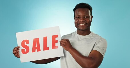 Poster - Happy black man, discount and sale sign for promotion, offer or advertising against a studio background. Portrait of African male person smile with poster for retail special, deal or store promo