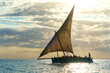 dramatic skyline with the dhow a traditional sailing vesssels of zanzibar tanzania