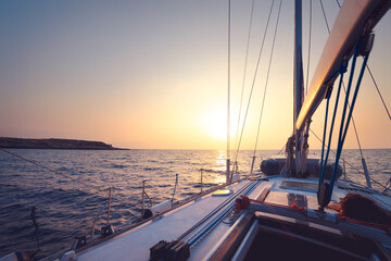 Wall Mural - Sailboat in mild sunset light