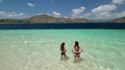 Poster - Woman and daughter standing in the sea