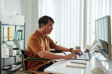 Wall Mural - Serious young businessman working on computer in his home office