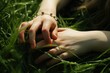 © Tisha - hands of mother and child who lie on green grass