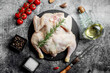 whole raw chicken on a stone background 