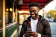 smiling black man texting on cell phone