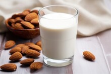 A Glass Of Almond Milk With Almond Nuts At The Bottom
