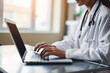© pariketan - Smiling female doctor giving advice to patient via laptop video call
