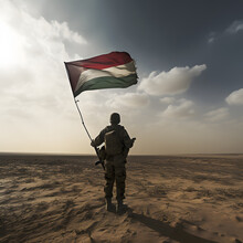 Silhouette Of A Soldier On Background Of The Sunrise And UAE Flag. Concept For Commemoration Day, Martyrs Day. Arab Military Man Stands In The Desert With A Flag