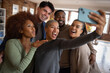 © ReeldealHD images - Group of friends taking a selfie in a loft apartment