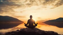 Man In Yoga Pose Zen Meditation At Sunset 
