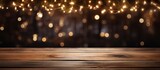 Fototapeta  - Wooden table with holiday lights in the evening