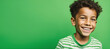 © evgeeenius - Excited smiling boy on solid green background