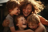 Fototapeta  - a woman is hugging three children and laughing