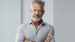 mature adult man gray hair and gray beard, arms crossed, wearing simple shirt, smiling with good mood, karrie and office, businessman, successful and calm, muscular