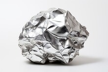 A Shiny, Crumpled Ball Of Aluminum Foil Rests On A Plain White Background.