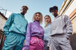 © artem - A diverse group of four young people wearing trendy athletic clothing gather outdoors