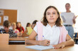 © JackF - Schoolgirl are sitting at their desks and listens carefully to the teacher in classroom