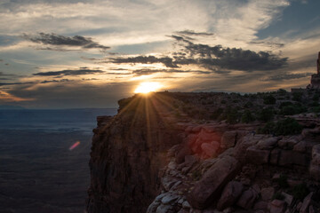 Poster - SunSet at Canyonlands national park in Utah; the warm golden sun setting behind a cliff. 