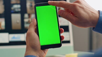 Wall Mural - Businessman hand swiping mockup smartphone at table closeup. Man tapping display