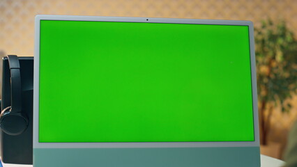 Wall Mural - man videocalling chromakey computer at table closeup. designer video conference