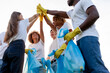 © Богдан Маліцький - team of volunteers in gloves and with garbage bags rejoice together at success and high five