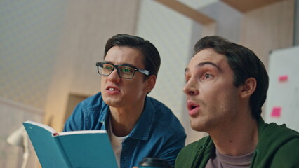 Wall Mural - Emotional partners staring computer screen at office closeup. Creators rejoicing