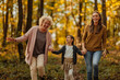 © bernardbodo - Mother, daughter and grandmother walking in the forest during autumn