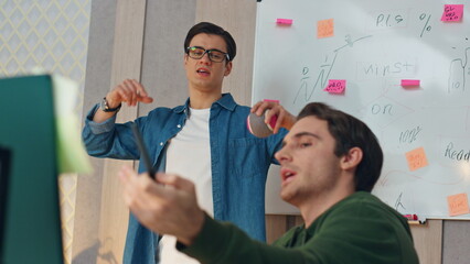 Wall Mural - Nervous guys discussing computer project closeup. Two startupers brainstorming
