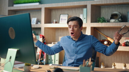 Wall Mural - Emotional businessman yelling computer videocall office. Nervous man gesturing