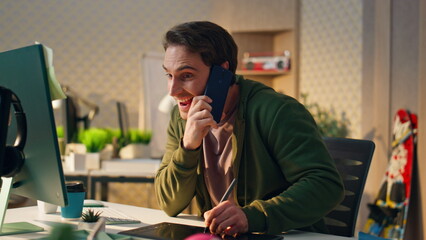 Wall Mural - Cheerful man speaking phone call office close up. Happy creator drawing tablet