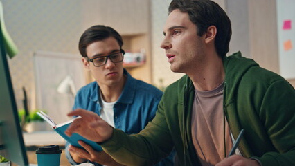 Wall Mural - Two men brainstorming computer at business place closeup. Teamwork cooperation